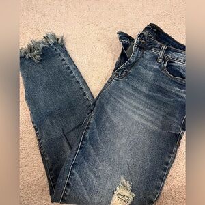 Dark frayed skinny distressed jeans